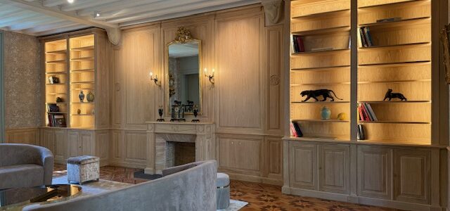 Exceptionnelle paire de bibliothèques avec boiseries, cheminée et sous bassement en châtaignier brut